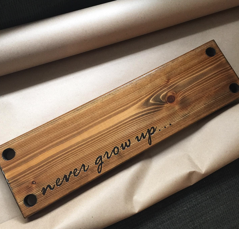 Never grow up hand engraved wooden swing